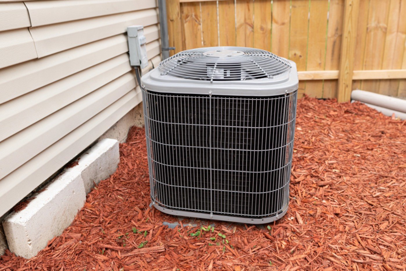 Hixon technician performing seasonal HVAC maintenance on a residential system in Dacula, GA